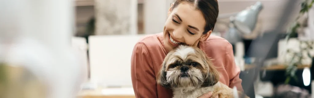 Smiling Valve+Meter team member holding an office dog